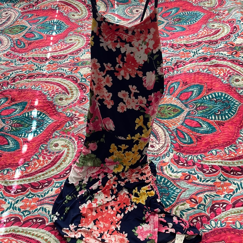 Body fitted dress. Sides have ruffles and back is open. I got this for my cruise